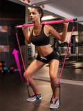 A person using a pink chest expander puller in a gym setting, with the equipment's rope and rod positioned diagonally across the body.